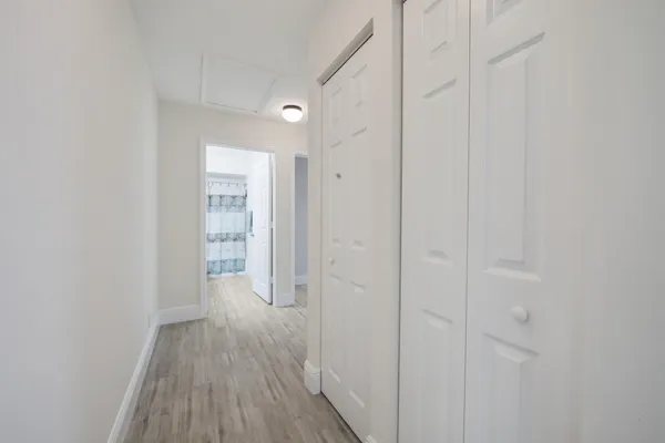 a view of a room with wooden floor