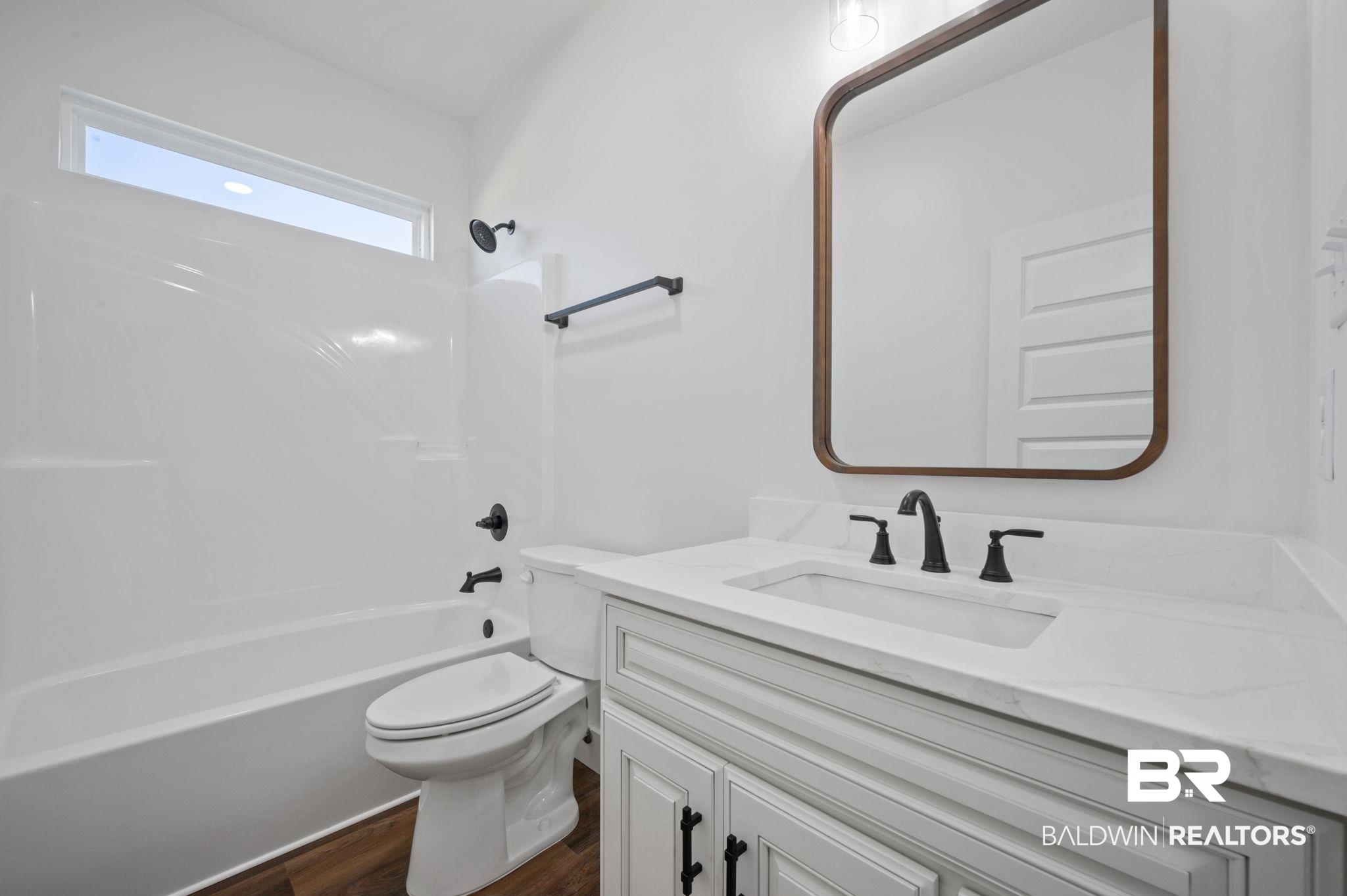 12100 Lott Road Chunchula, AL 36521 - Photo 15 of 21 Full bathroom with hardwood / wood-style flooring, bathing tub / shower combination, toilet, and vanity