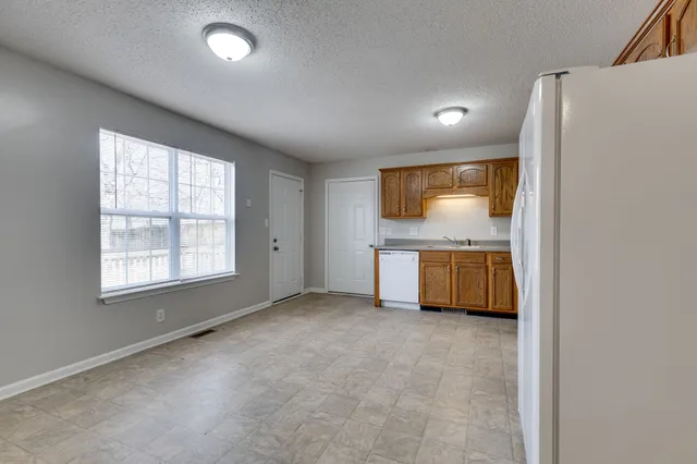 a front view of house with yard and trees around