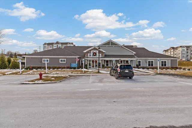 a city street filled with lots of tall buildings and parked cars