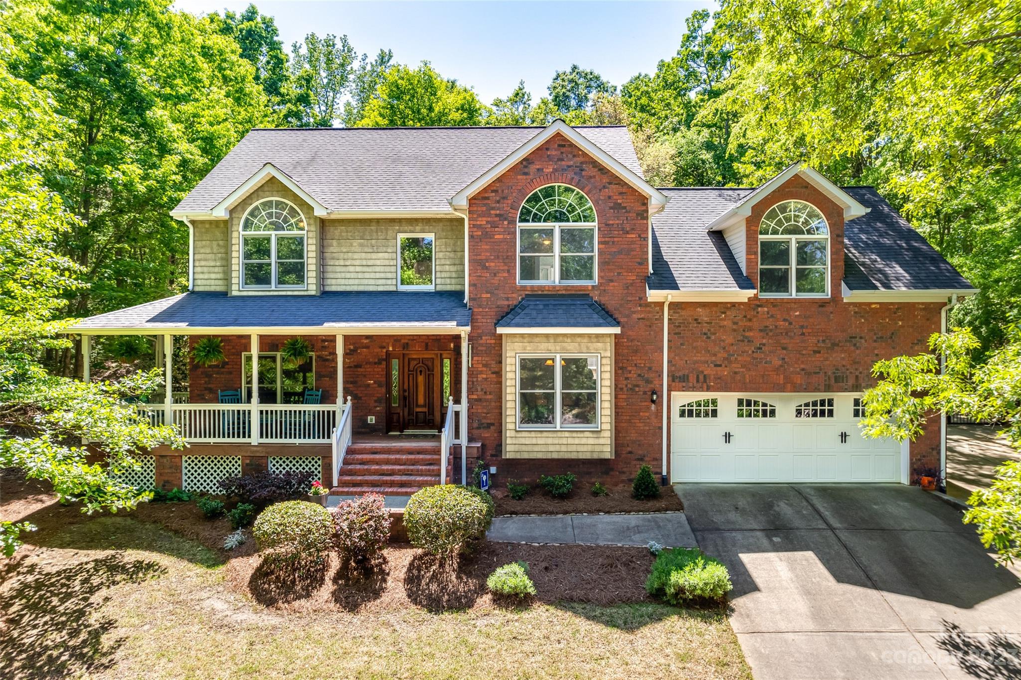 12005 Forest Garden Fort Mill, SC 29708 - Photo 1 of 48 a front view of a house with garden