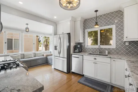 a kitchen with granite countertop a refrigerator and a sink