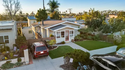 a view of a house with backyard sitting area and garden