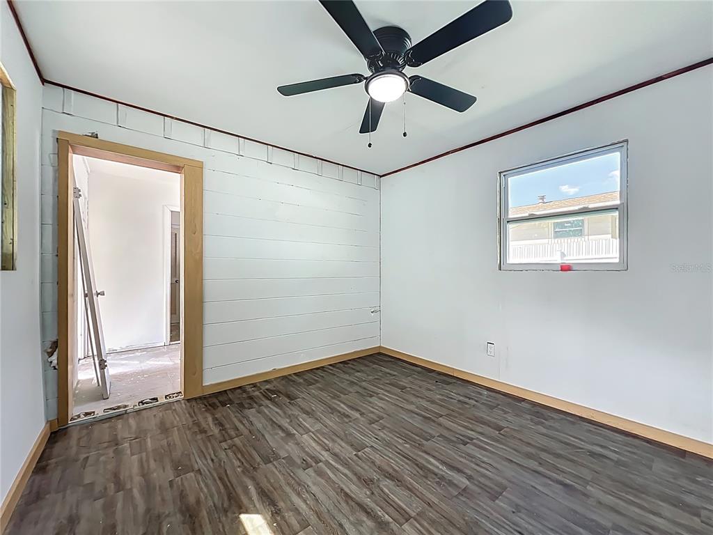 20 Lake Ct Loop Ocala, FL 34472 - Photo 20 of 33 an empty room with wooden floor fan and windows