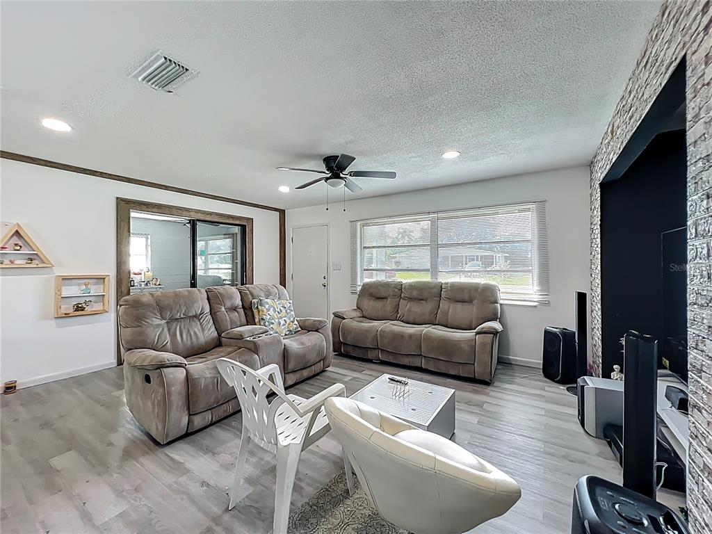 20 Lake Ct Loop Ocala, FL 34472 - Photo 6 of 33 a living room with furniture and a flat screen tv