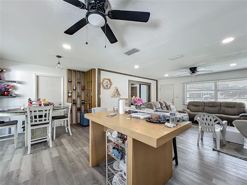20 Lake Ct Loop Ocala, FL 34472 - Photo 9 of 33 a kitchen with a stove a refrigerator and a dining table with wooden floor