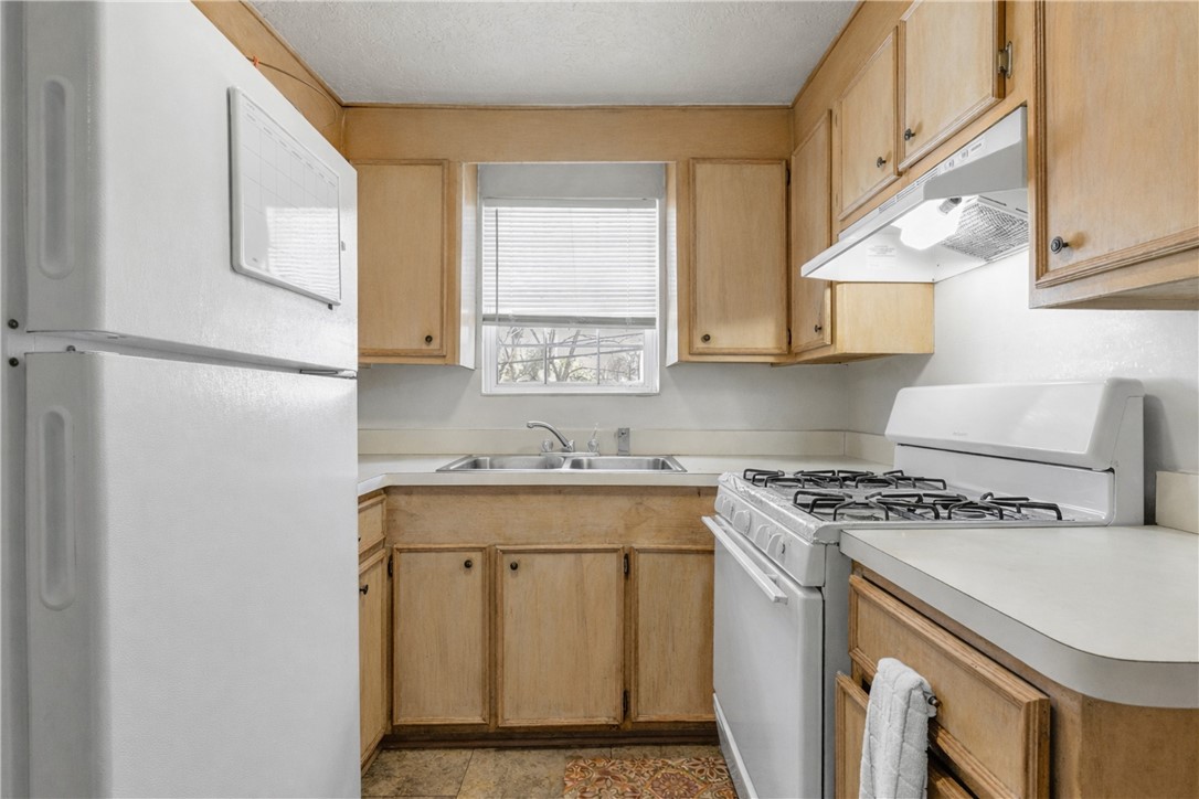 1012 Columbus Avenue Bryan, TX 77803 - Photo 3 of 9 a kitchen with a stove a sink and a refrigerator