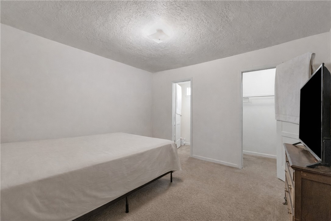 1012 Columbus Avenue Bryan, TX 77803 - Photo 4 of 9 a bed sitting in a room next to a flat screen tv