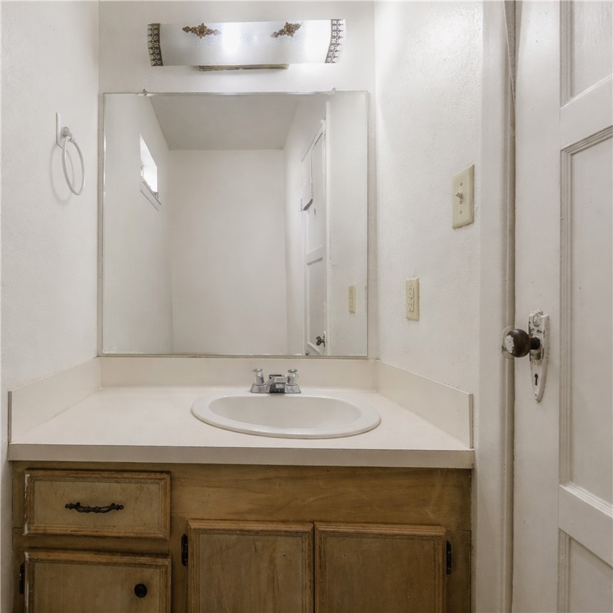 1012 Columbus Avenue Bryan, TX 77803 - Photo 5 of 9 a bathroom with a sink and a mirror