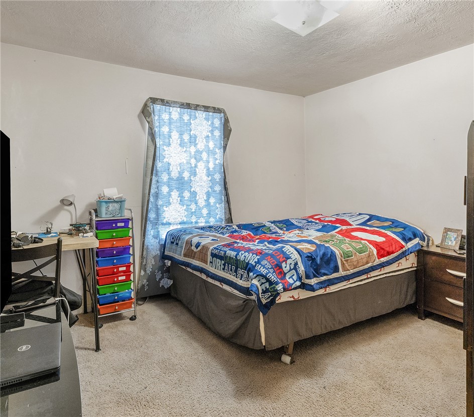 1012 Columbus Avenue Bryan, TX 77803 - Photo 7 of 9 a bedroom with a bed and dresser