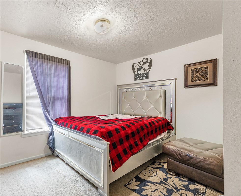 1012 Columbus Avenue Bryan, TX 77803 - Photo 8 of 9 a bed sitting in a bedroom next to a window
