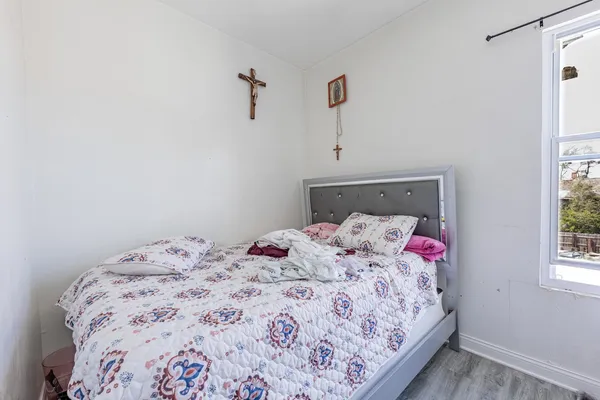 a bedroom with a bed and a window