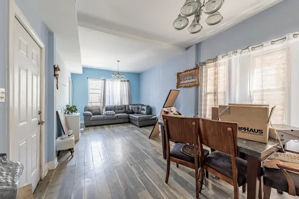 a view of a livingroom with furniture window and wooden floor
