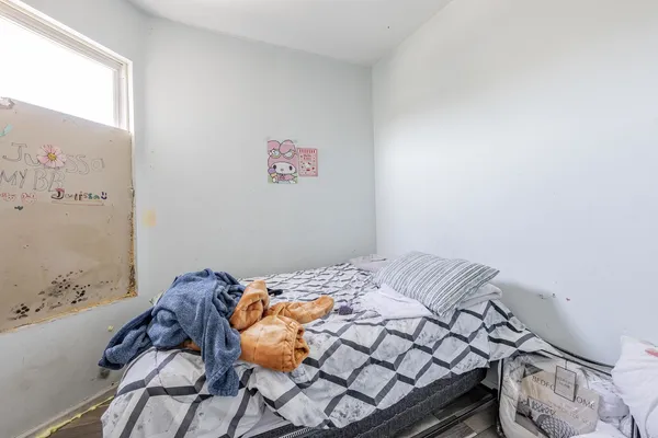 a bedroom with a bed and a wall painting