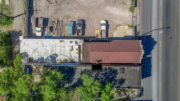 an aerial view of a house with a yard