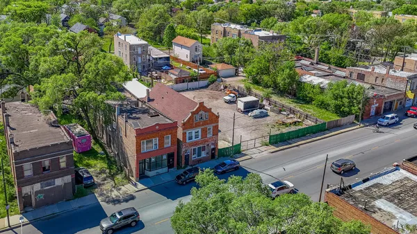 an aerial view of multiple houses with yard