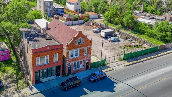 a aerial view of multiple houses with yard