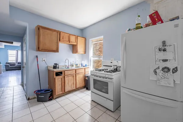 a kitchen with stainless steel appliances a stove a sink and a refrigerator