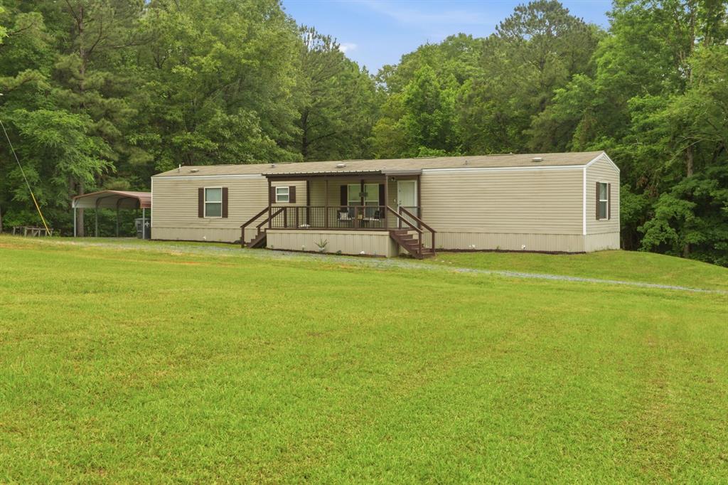 127 Almond Road Minden, LA 71055 - Photo 2 of 25 a front view of a house with yard and trees