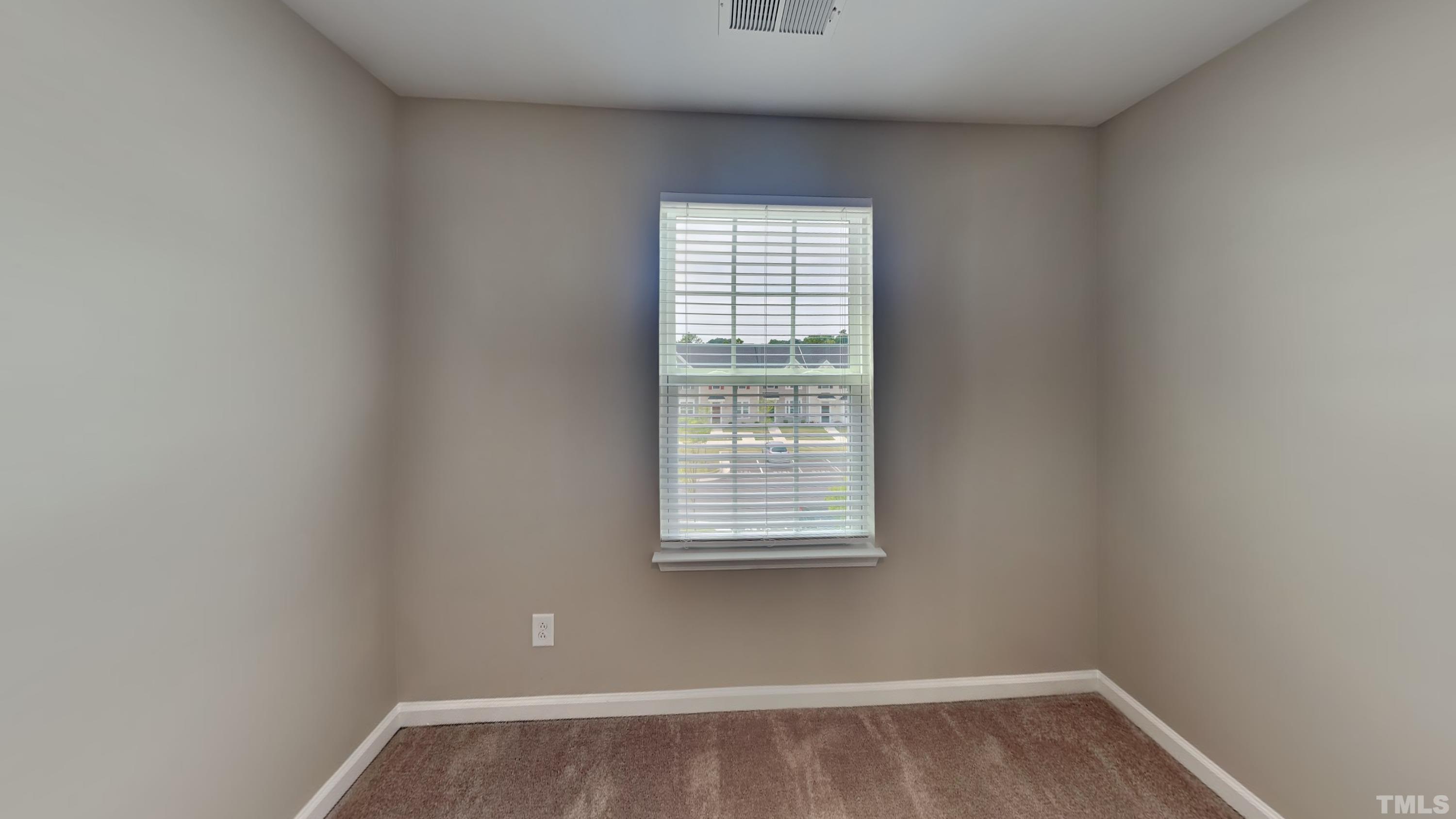 8720 Red Canyon Way Raleigh, NC 27616 - Photo 12 of 14 a view of an empty room with wooden floor and a window