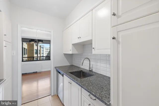 a kitchen with stainless steel appliances granite countertop a stove and a microwave