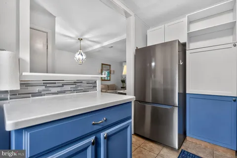 a kitchen with a refrigerator and a sink