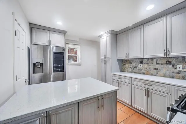 a kitchen with stainless steel appliances a refrigerator sink and cabinets