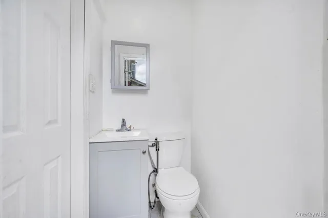 a bathroom with a sink a toilet and mirror