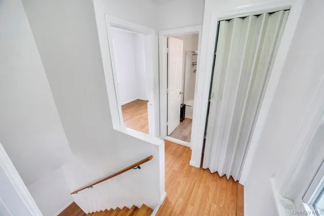 a view of a hallway with wooden floor and entryway
