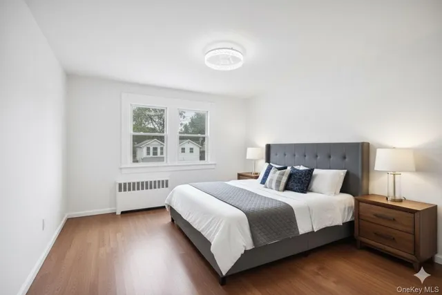 a bedroom with a bed and a night stand