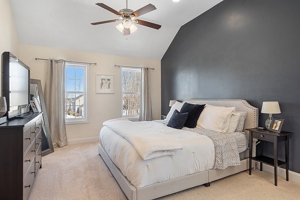 21 Butternut Road Dracut, MA 01826 - Photo 18 of 28 a bedroom with a large bed and a flat tv screen on a dresser