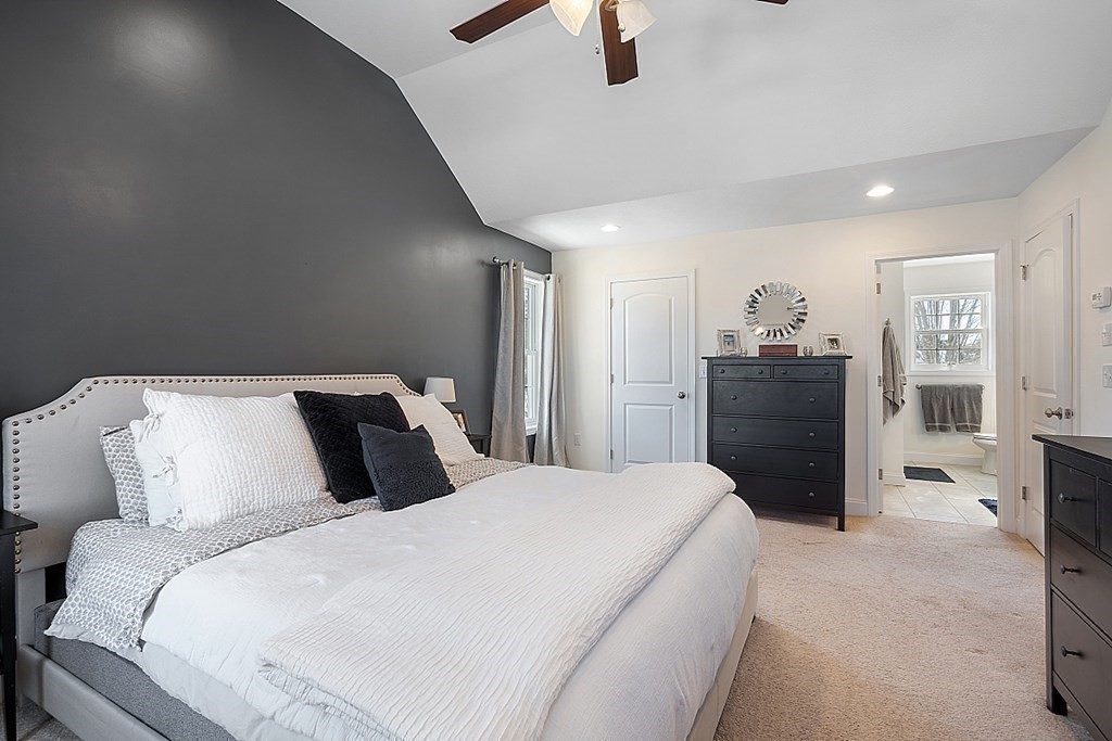 21 Butternut Road Dracut, MA 01826 - Photo 19 of 28 a bedroom with a bed and a chandelier