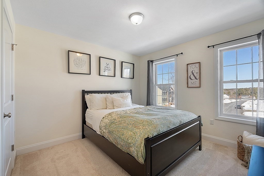 21 Butternut Road Dracut, MA 01826 - Photo 21 of 28 a bed room with a bed and a window