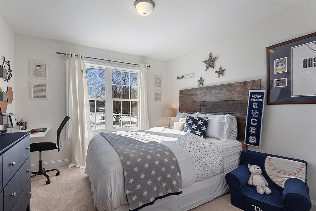 21 Butternut Road Dracut, MA 01826 - Photo 22 of 28 a bedroom with a bed and wooden floor