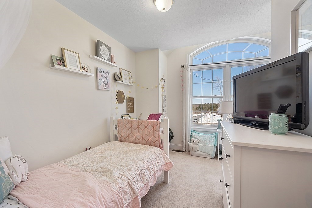 21 Butternut Road Dracut, MA 01826 - Photo 23 of 28 a bedroom with a bed and a flat screen tv