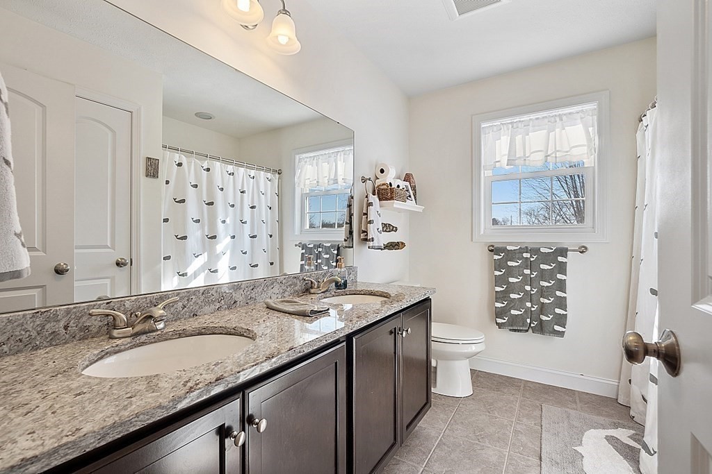 21 Butternut Road Dracut, MA 01826 - Photo 24 of 28 a bathroom with a granite countertop double vanity sink toilet and shower