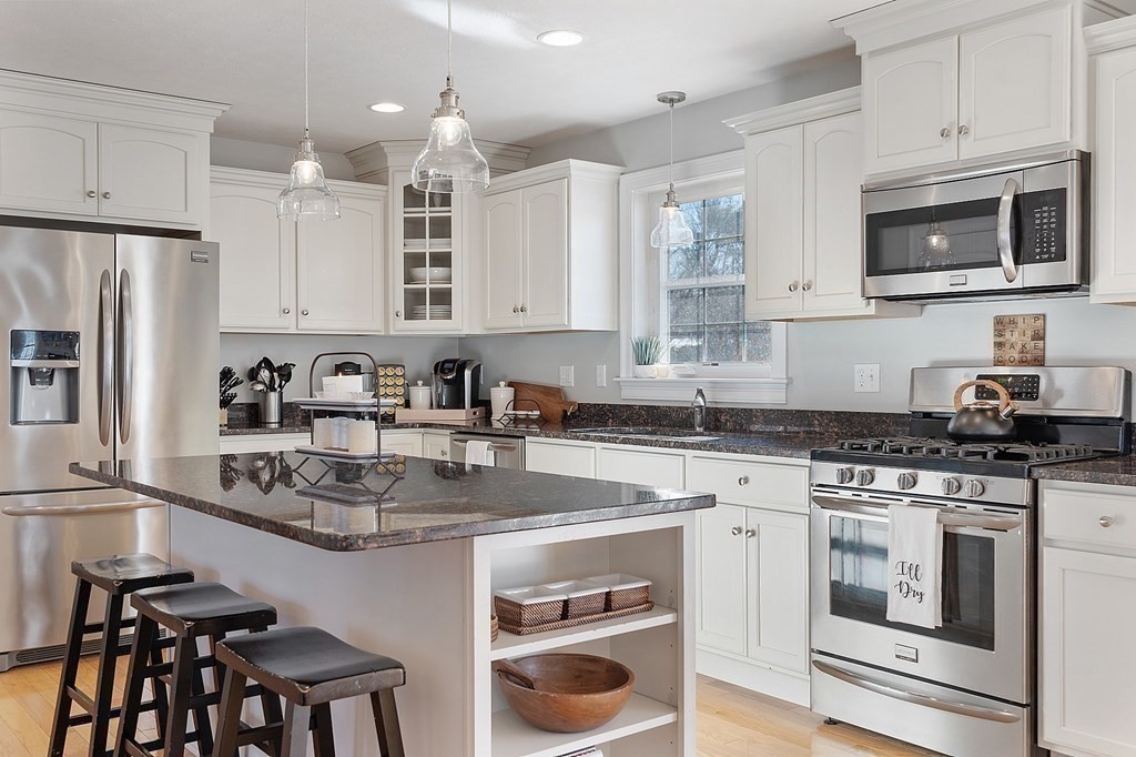 21 Butternut Road Dracut, MA 01826 - Photo 6 of 28 a kitchen with a stove a sink and a microwave