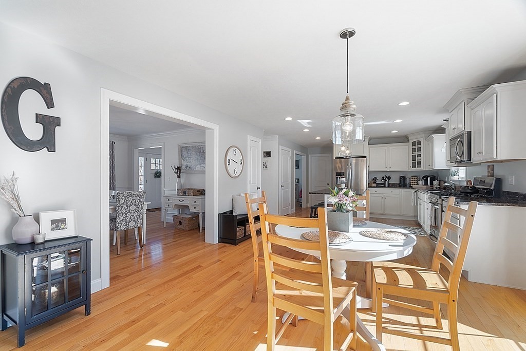 21 Butternut Road Dracut, MA 01826 - Photo 9 of 28 a view of a dining room and livingroom with furniture wooden floor a chandelier