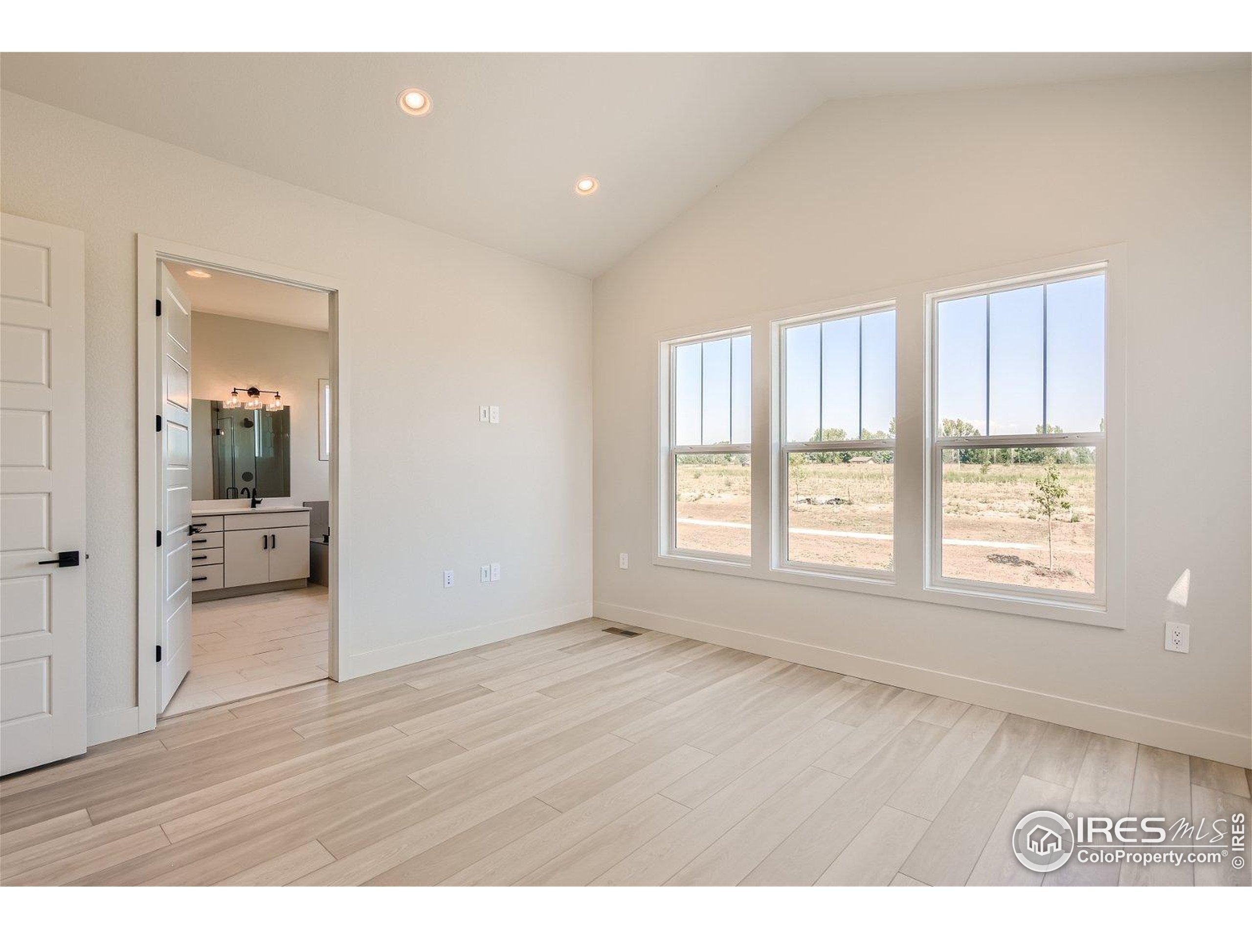 1726 Morningstar Way Fort Collins, CO 80524 - Photo 13 of 29 a big room with wooden floor and a bathroom