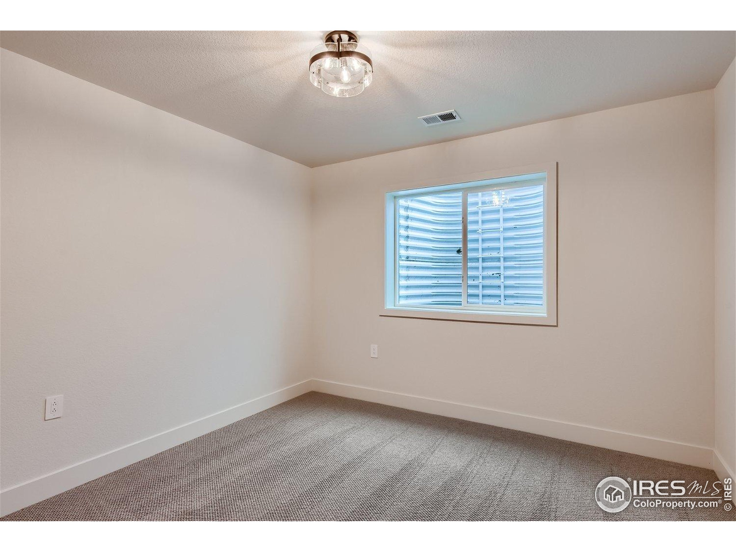 1726 Morningstar Way Fort Collins, CO 80524 - Photo 23 of 29 an empty room with wooden floor and windows