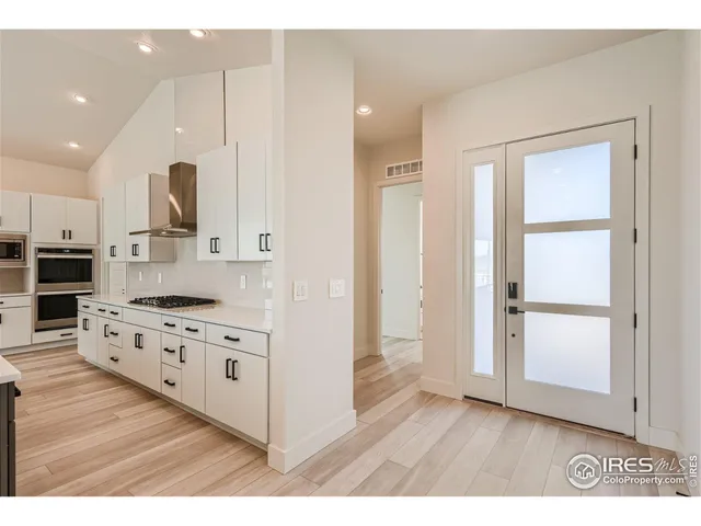 a kitchen with granite countertop a refrigerator and a stove
