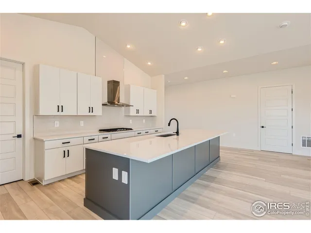 view of kitchen island with stove and cabinets