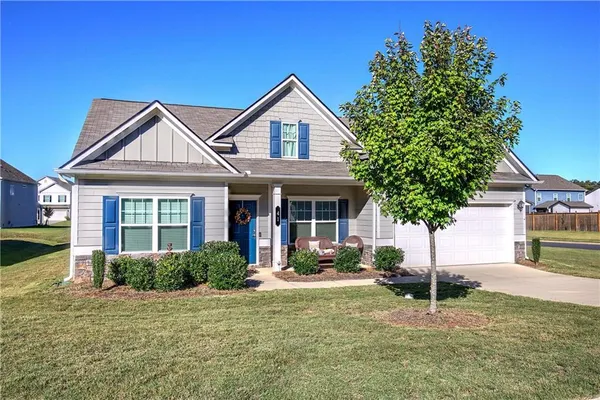 a front view of a house with garden