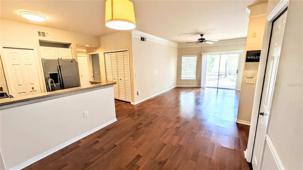 5174 Northridge Road, Unit 102 Sarasota, FL 34238 - Photo 3 of 39 a view of a big room with wooden floor and windows