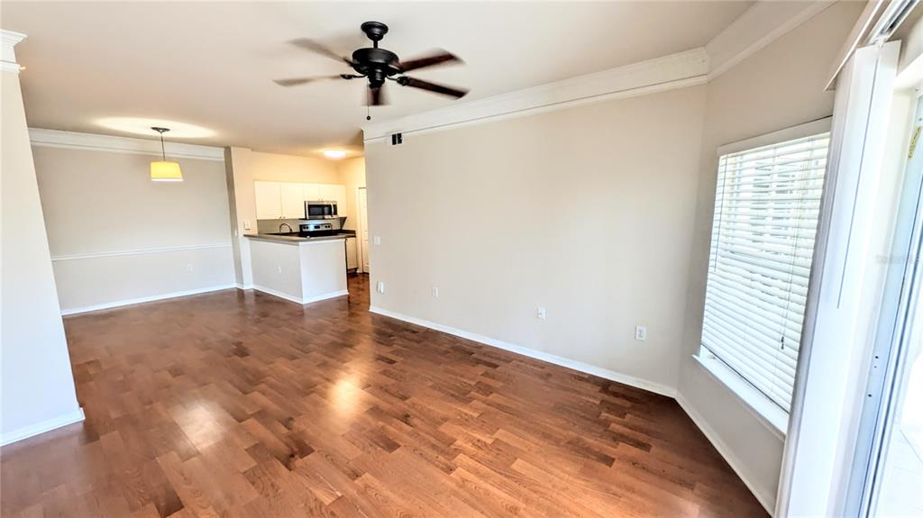 5174 Northridge Road, Unit 102 Sarasota, FL 34238 - Photo 4 of 39 a view of empty room with wooden floor and fan