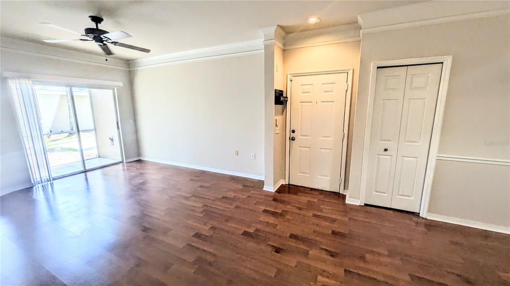 5174 Northridge Road, Unit 102 Sarasota, FL 34238 - Photo 6 of 39 a view of empty room with wooden floor and fan