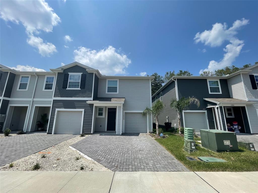 13808 Northwest 9th Road Newberry, FL 32669 - Photo 1 of 24 a front view of a house with garden