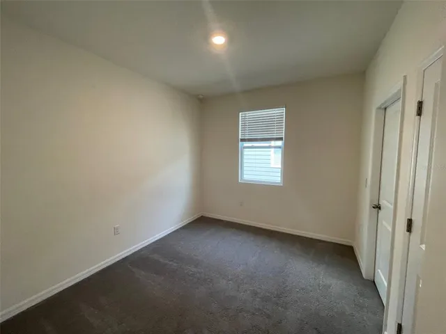 an empty room with a empty space and windows