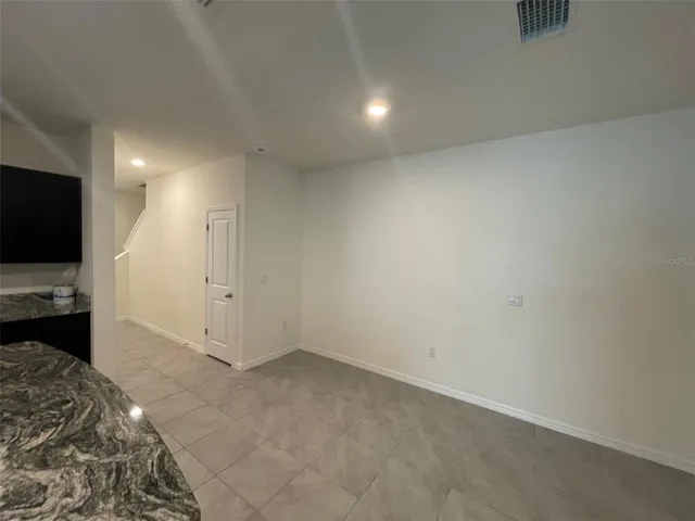 a view of a livingroom with wooden floor and a flat screen tv
