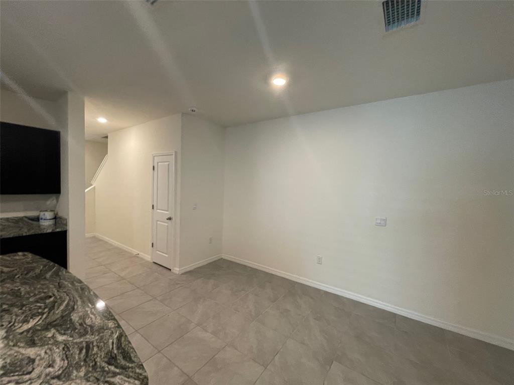 13808 Northwest 9th Road Newberry, FL 32669 - Photo 22 of 24 a view of a livingroom with wooden floor and a flat screen tv